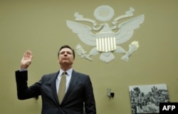 FILE - FBI Director James Comey is sworn in before a House Oversight and Government Reform Committee hearing on Capitol Hill in Washington, D.C., July 7, 2016. Comey's announcement that authorities were again looking into Clinton's email practices sparked criticism that his agency was intervening in the U.S. presidential race.