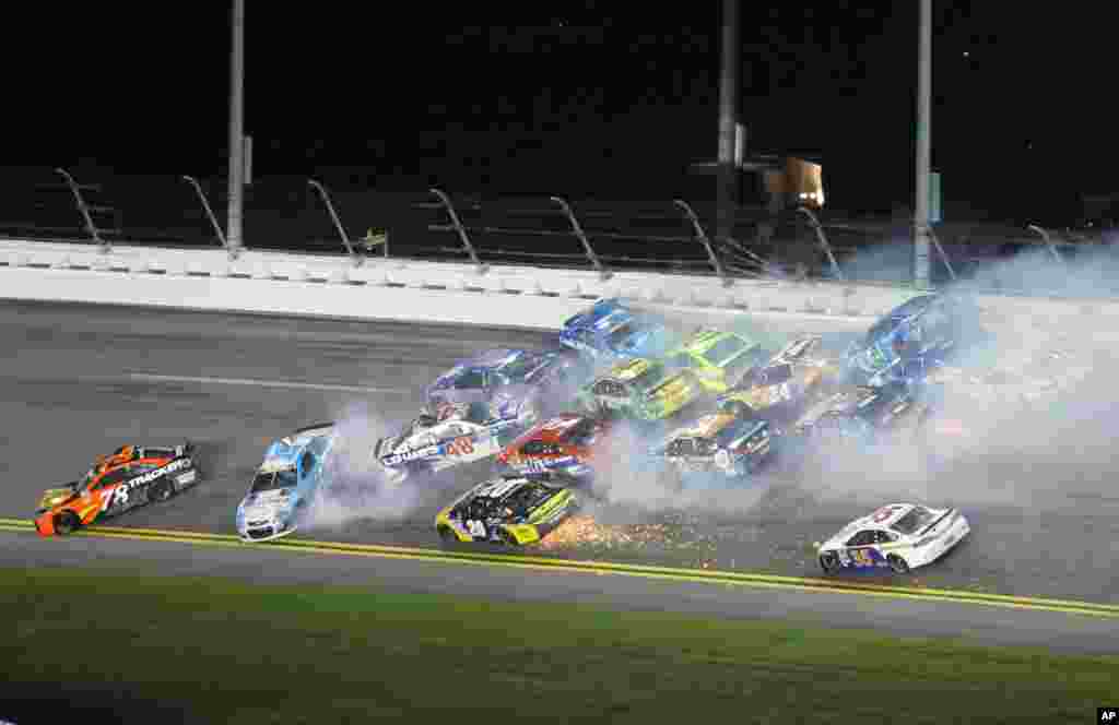 Jamie McMurray (1), Greg Biffle (16), Jimmie Johnson (48), Martin Truex Jr. (78), Danica Patrick (10) Ryan Newman (31), Chris Buescher (34), Paul Menard (27), Chase Elliott (24), Matt Kenseth (20), David Gilliland (35) and others wreck during the NASCAR Sprint Cup Series auto race at Daytona International Speedway in Daytona Beach, Florida, July 2, 2016.