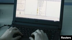 FILE - A laptop shows part of a code, which is the component of Petya malware computer virus, according to representatives of Ukrainian cybersecurity firm ISSP, at the firm's office in Kyiv, Ukraine, July 4, 2017. 