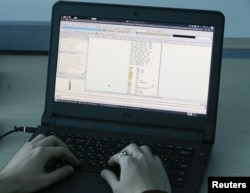 FILE - A laptop shows part of a code, which is the component of the Petya malware computer virus, according to representatives of Ukrainian cybersecurity firm ISSP, at the firm's office in Kyiv, Ukraine, July 4, 2017. A variant, dubbed NotPetya, was used for a global cyberattack in June 2017.