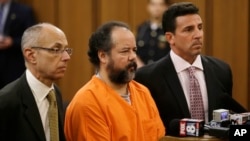 Ariel Castro, center, stands before a judge with his defense attorneys, Jaye Schlachet, left, and Craig Weintraub during Castro's arraignment on an expanded 977-count indictment, July 17, 2013, in Cleveland. 