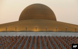 Thai Buddhist monks pray and gather at Wat Dhammakaya temple in Pathum Thani, Thailand, Feb. 22, 2016.