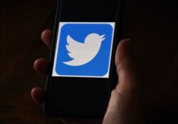 n this file photo illustration, a Twitter logo is displayed on a mobile phone on May 27, 2020, in Arlington, Virginia.