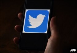 n this file photo illustration, a Twitter logo is displayed on a mobile phone on May 27, 2020, in Arlington, Virginia.