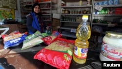 A worker sells subsidized food commodities at a government-run supermarket in Cairo, Egypt, Feb.14, 2016. 