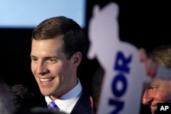 FILE - Conor Lamb, the Democratic candidate for the March 13 special election in Pennsylvania's 18th Congressional District, celebrates with his supporters at his election night party in Canonsburg, Pa., March 14, 2018.