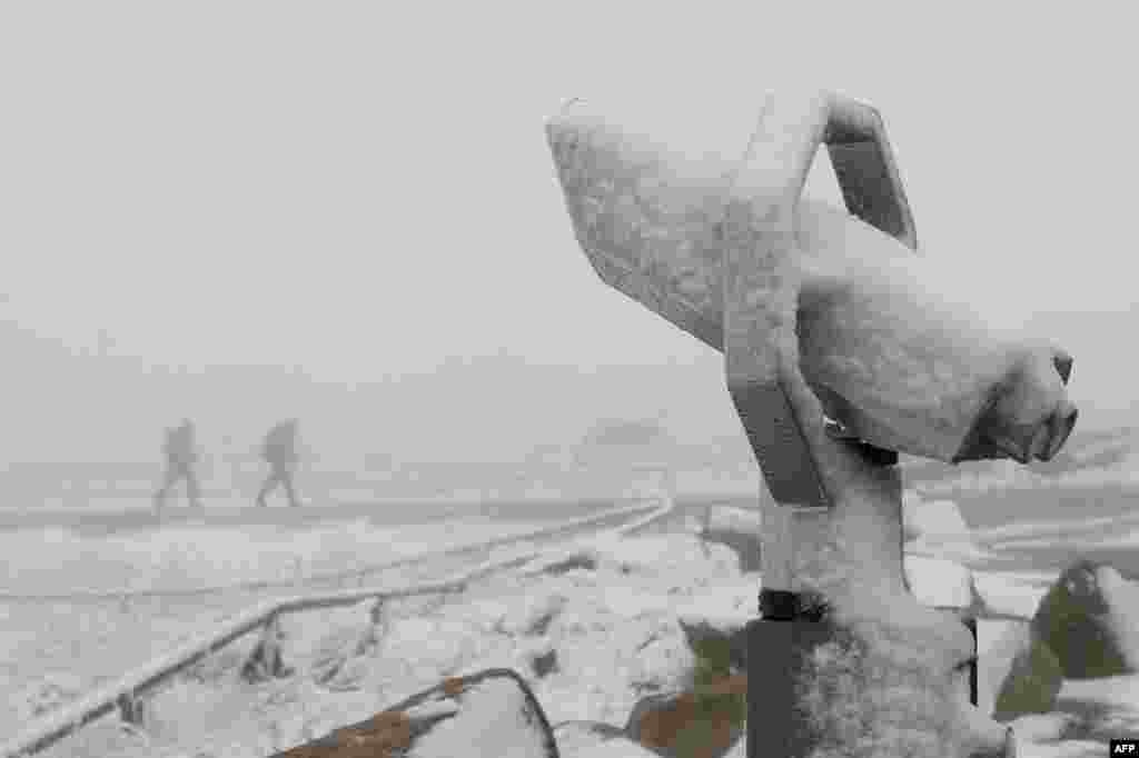 Field glasses are covered with snow on the top of the Brocken, eastern Germany.