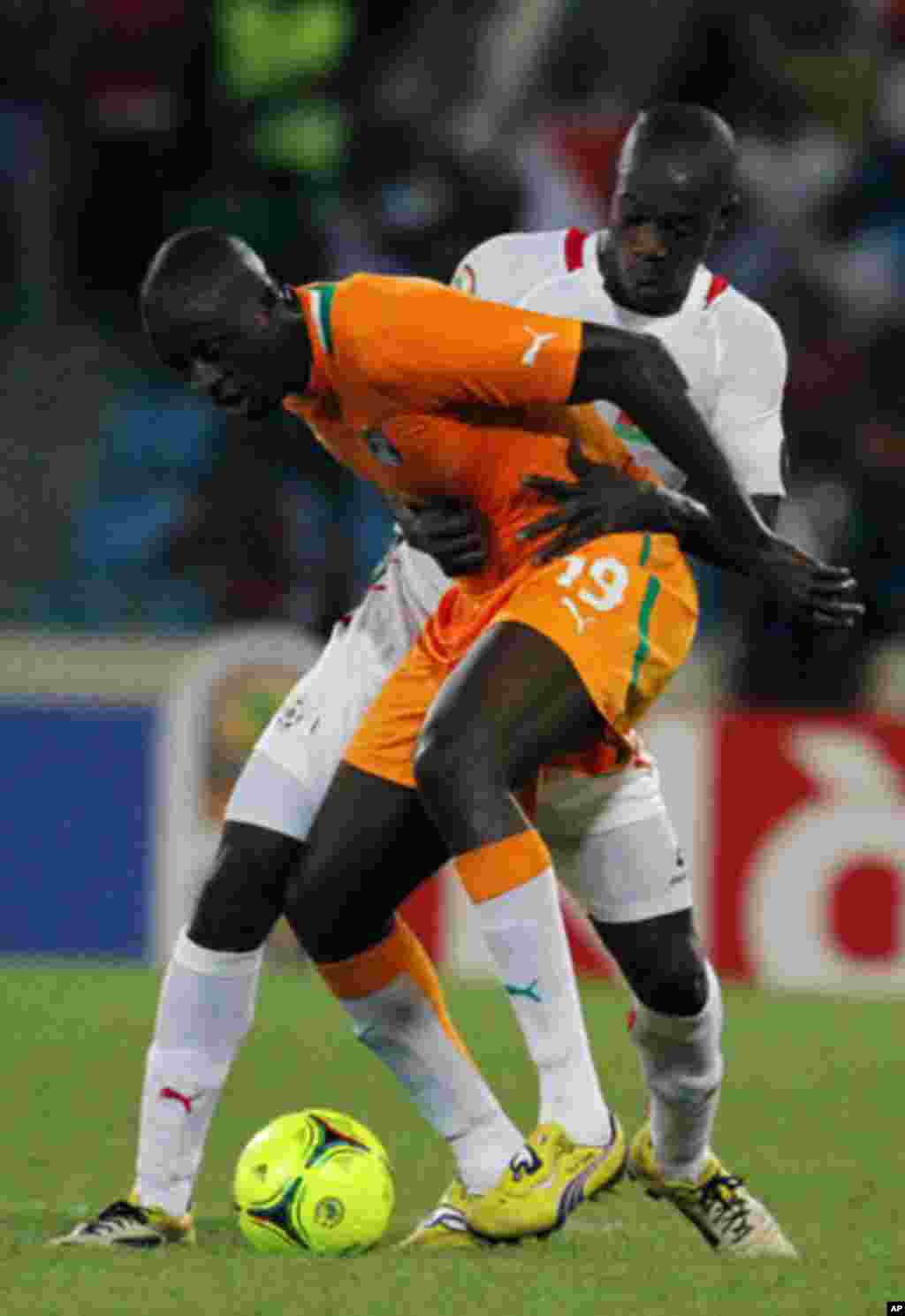 Toure of Ivory coast fights for the ball with Kere of Burkina Faso during their African Nations Cup soccer match in Malabo