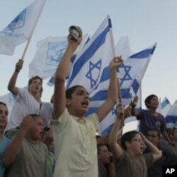 Settler youth from the settlement of Itamar in the West Bank march down a highway to demonstrate their ownership of the land, September 21, 2011