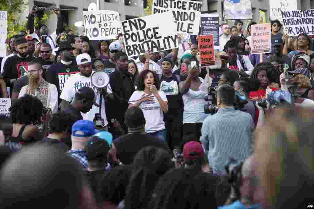 People rally in Dallas, Texas, on Thursday, July 7, 2016 to protest the deaths of Alton Sterling and Philando Castile.