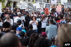 People rally in Dallas, Texas, on Thursday, July 7, 2016 to protest the deaths of Alton Sterling and Philando Castile.