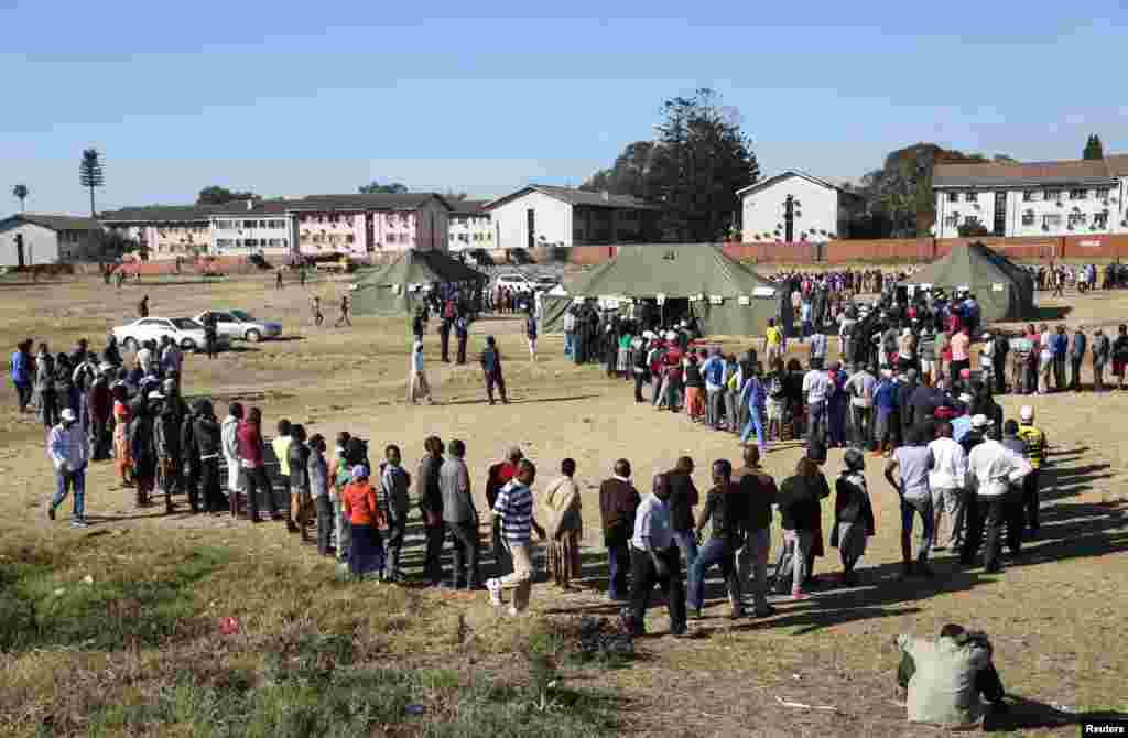 Voters queue to cast their ballots in the general elections in Harare, Zimbabwe.