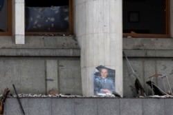 A portrait of former Kazakhstan President Nursultan Nazarbayev is seen at the city hall building after clashes between anti-governnment demonstrators and security forces, in the central square of Almaty, Kazakhstan, Jan. 10, 2022.