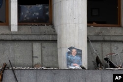 A portrait of former Kazakhstan President Nursultan Nazarbayev is seen at the city hall building after clashes between anti-governnment demonstrators and security forces, in the central square of Almaty, Kazakhstan, Jan. 10, 2022.