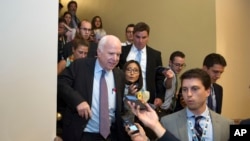 Sen. John McCain, R-Arizona, front left, is pursued by reporters after casting a "no" vote on a measure to repeal parts of former president Barack Obama's health care law, on Capitol Hill in Washington, July 28, 2017. 