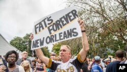 FILE - Fans parade down Poland Avenue toward the former home of music legend Antoine 'Fats' Domino during a second line parade honoring him on Nov. 1, 2017 in New Orleans.