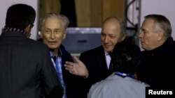 In this 2013 file photo, Former French hostage Francis Collomp (2ndL) is welcomed by relatives and officials including Prime Minister Jean-Marc Ayrault (R) and Foreign Affairs minister Laurent Fabius at Villacoublay military airport, near Paris.