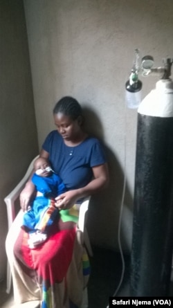 Pretty Mandere and son, Taropafadzwa by the oxygen tank