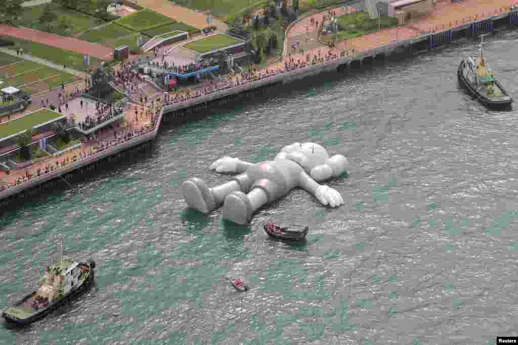 A huge &#39;Companion&#39; inflatable sculpture by U.S. artist Brian Donnelly, known professionally as Kaws, is displayed at the Victoria Harbor in Hong Kong, China.