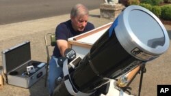 Amateur astronomer Mike Conley practices with the telescope he will use to document the Aug. 21 total solar eclipse, at his home in Salem, Ore., Aug. 3, 2017. Conley is part of a project led by the National Solar Observatory to have dozens of citizen scientists posted across the U.S. photograph the celestial event in an effort to create a live movie of its path that will help scientists learn more about the sun's corona.