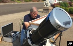 Amateur astronomer Mike Conley practices with the telescope he will use to document the Aug. 21 total solar eclipse, at his home in Salem, Ore., Aug. 3, 2017.