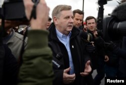 U.S. congressional candidate and State Rep. Rick Saccone navigates through the media to cast his vote in Pennsylvania's 18th U.S. Congressional district special election at a polling place in McKeesport, Pennsylvania, March 13, 2018.