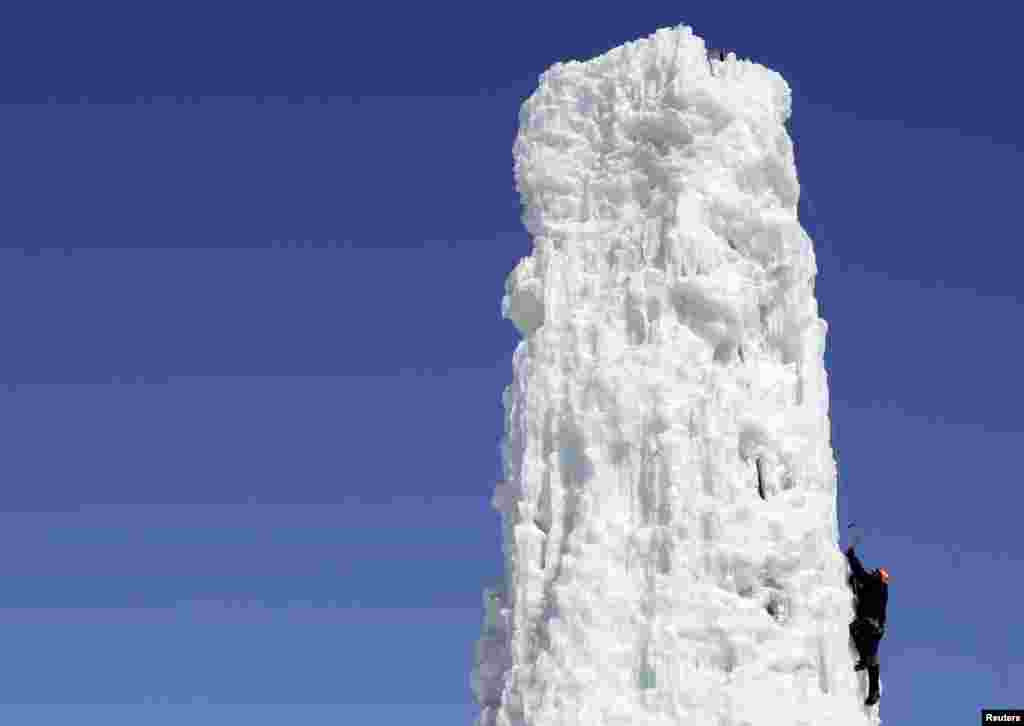 A man climbs an ice column at the Climbing Club of St. Boniface in Winnipeg, Manitoba, Canada, Mar. 27, 2014.