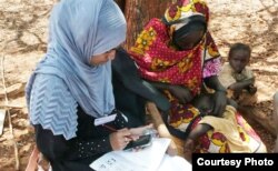 FILE - Red Cross volunteer uses a mobile phone to gather health information in rural Kenya. (Credit: IFRC)