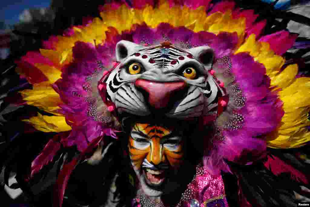 A member of the &quot;Congo Reformado&quot; folk group poses for a portrait before a parade at the 12th International Festival of the Iberian Mask in Lisbon, Portugal.