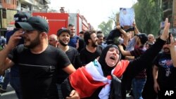 Iraqis grieve during the funeral procession of bomb victim, Akram Hadi, 24, who was killed in a massive truck bomb attack in the Karada neighborhood of Baghdad, Iraq, July 5, 2016. 