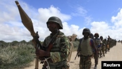 FILE - African Union Mission in Somalia (AMISOM) peacekeepers from Burundi patrol after fighting between insurgents and government soldiers erupted on the outskirts of Mogadishu.