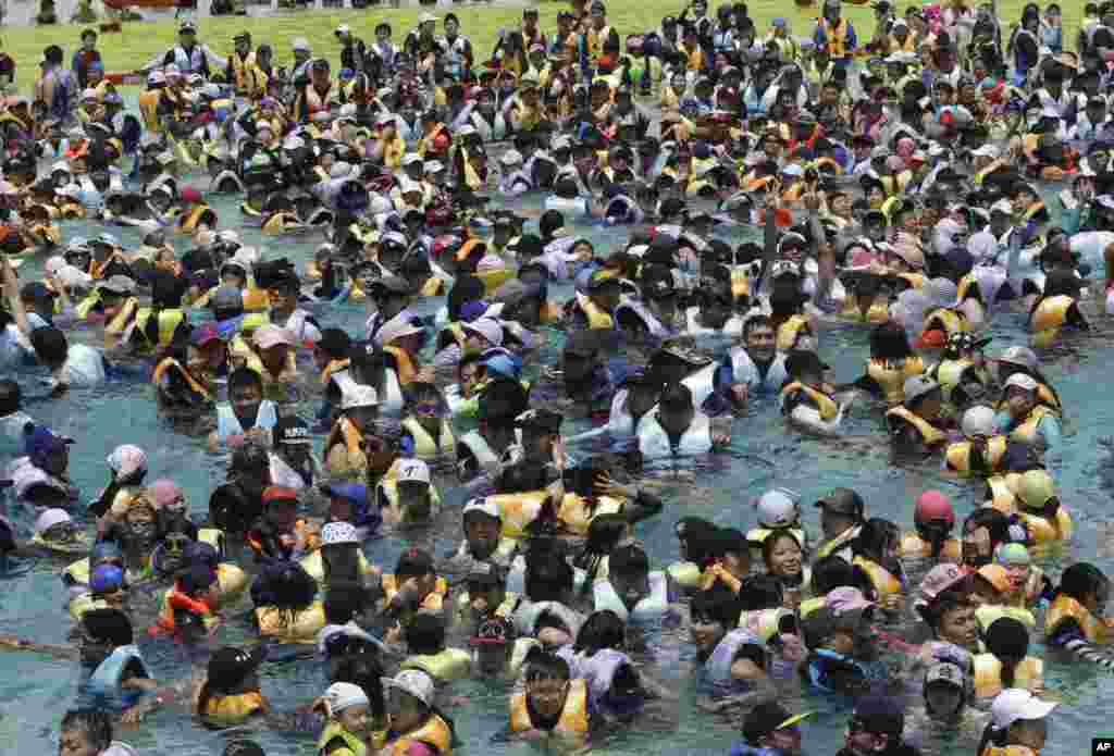 People crowd the Caribbean Bay swimming pool as they try to escape a heat, in Yongin, South Korea.