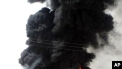 Column of black smoke billows from oil pipeline, that runs about six kilometers (four miles) east of Marib in eastern Yemeni province of same name, after it was blown up by Yemeni tribesmen, 12 Jun 2010