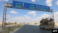 Residents of Idlib province flee toward the Syrian Turkish border on Sept. 10, 2018. 