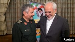 Islamic Revolutionary Guard Corps (IRGC) commander Mohammad Ali Jafari, left, and Iran's Foreign Minister Mohammad Javad Zarif smile during a coordination meeting for the 40th anniversary of the Islamic Revolution, in Tehran, Iran, Oct. 9, 2017. 