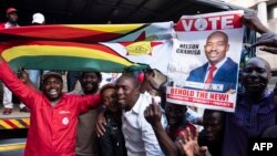 Supporters of MDC (Movement for Democratic Change Alliance) leader and opposition presidential candidate cheer outside the MDC headquarters in Harare, on July 31, 2018.