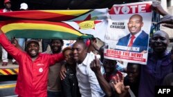 FILE: Supporters of MDC (Movement for Democratic Change Alliance) leader and opposition presidential candidate cheer outside the MDC headquarters in Harare, on July 31, 2018. 