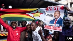 Supporters of MDC (Movement for Democratic Change Alliance) leader and opposition presidential candidate cheer outside the MDC headquarters in Harare, on July 31, 2018.