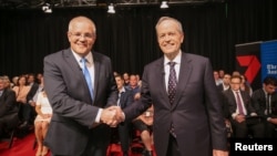 FILE - Australian Prime Minister Scott Morrison and Opposition Leader Bill Shorten shake hands before the first leaders forum at the Seven West Media Studios in Perth, Australia, April 29, 2019. (AAP Image/ The West Australian Pool/via Reuters)