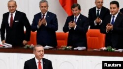 Turkey's President Recep Tayyip Erdogan, lower left, attends a debate marking the reconvening of parliament after a summer recess at the Turkish Parliament in Ankara, Oct. 1, 2014. 