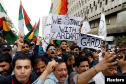 Supporters of Pakistan People's Party (PPP) carrying signs and flags chant slogans to condemn the arrest of former president Asif Ali Zardari by National Accountability Court (NAB) in Islamabad, during a protest in Karachi, Pakistan, June 10, 2019.