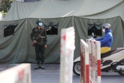 FILE - A military checkpoint is seen during lockdown amid the COVID-19 pandemic in Ho Chi Minh, Vietnam, Aug. 23, 2021.