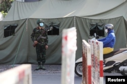 FILE - A military checkpoint is seen during lockdown amid the COVID-19 pandemic in Ho Chi Minh, Vietnam, Aug. 23, 2021.