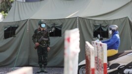 FILE - A military checkpoint is seen during lockdown amid the COVID-19 pandemic in Ho Chi Minh, Vietnam, August 23, 2021.
