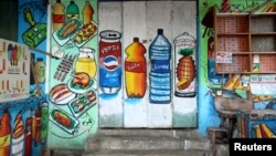 FILE - A mural on the exterior wall of a store illustrates food and drinks in a commercial district of Mogadishu, Somalia, June 8, 2017.