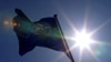 FILE - A NATO flag flies at the Alliance headquarters in Brussels, March 2, 2014.