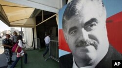 Visitors enter to pay their respect at the grave of Lebanon's assassinated former prime minister Rafik al-Hariri, in downtown Beirut June 30, 2011