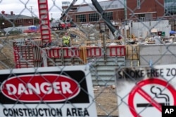 In this Oct. 25, 2017, photo, construction workers build the foundation of the newest Erie Insurance building on French Street in Erie, Pa.