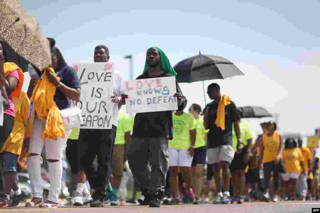 Demonstrators walk along West Florissant Avenue, Aug. 23, 2014 in Ferguson, Missouri. 