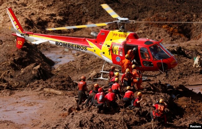 Members of a rescue team search for victims after a tailings dam owned by Brazilian mining company Vale SA collapsed, in Brumadinho, Brazil, Jan. 28, 2019.